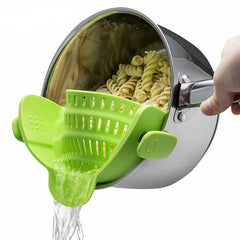 Snap-on silicone strainer attached to the edge of a pot