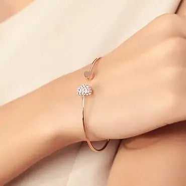 Delicate golden bracelet featuring a heart-shaped charm
